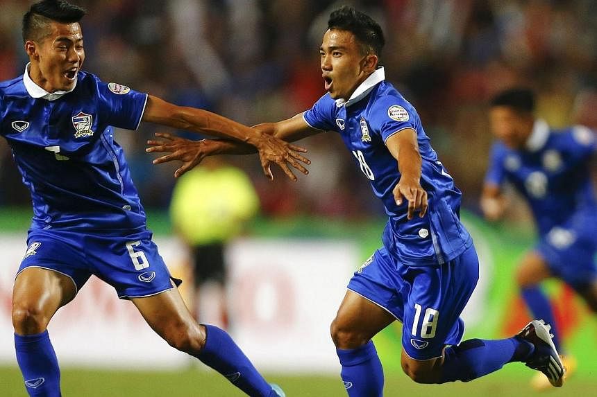 Chanathip Songkrasin (centre) of Thailand celebrates scoring against Philippines during their second leg semi final match of AFF Suzuki Cup 2014 in Bangkok on Dec 10, 2014.&nbsp;Two goals by Kroekrit Thaweekarn and another by Chanathip Songkrasin sen
