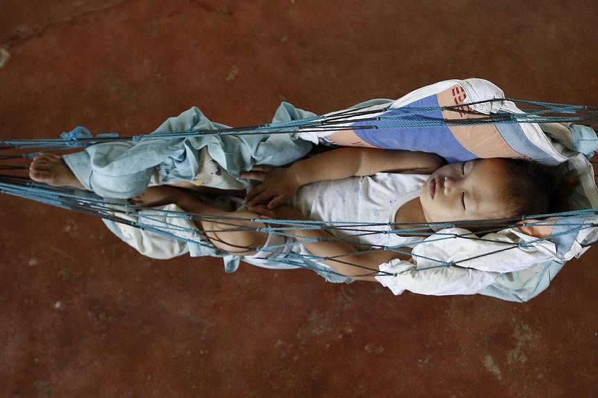 A baby sleeps in a hammock at an evacuation centre for Typhoon Hagupit victims in San Julian, Eastern Samar in central Philippines. Emergency workers were struggling on Tuesday to reach coastal villages on an island hardest hit by a typhoon. Nearly 1