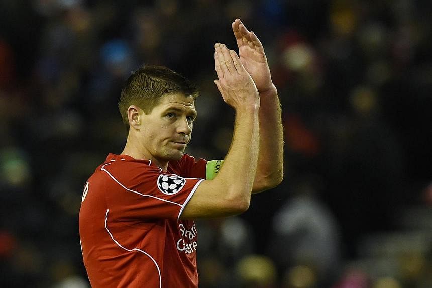 Liverpool's English midfielder Steven Gerrard applauds the fans at the end of the UEFA Champions League group B football match between Liverpool and Basel at Anfield in Liverpool, north west England, on Dec 9, 2014. The final score was 1-1. -- PHOTO: