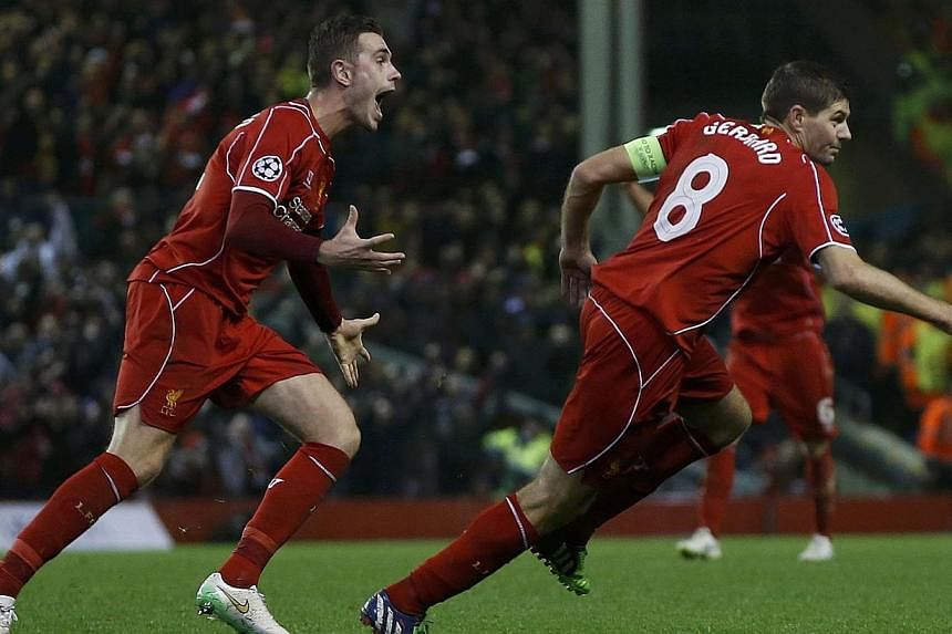Liverpool's Steven Gerrard (right) celebrates his goal against FC Basel with Jordan Henderson during their Champions League Group B soccer match at Anfield in Liverpool, northern England, Dec 9, 2014. -- PHOTO: REUTERS
