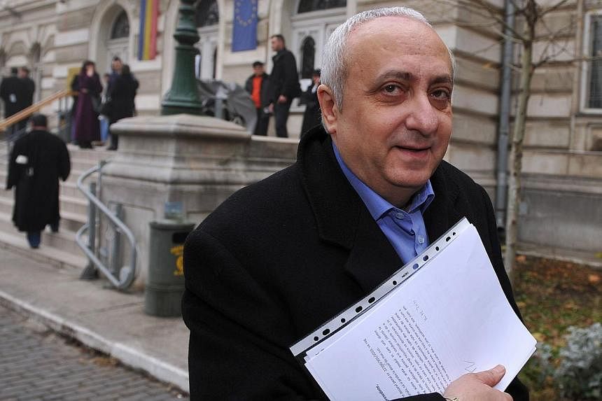A 2011 file photo shows former Romanian diplomat Silviu Ionescu leaving Bucharest's courthouse after a hearing. Ionescu died on Tuesday in a Bucharest jail hospital, local media reported. -- PHOTO: AFP&nbsp;