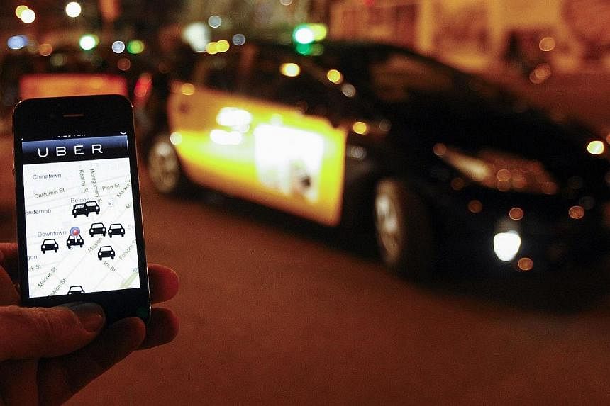 The Uber app is seen on a smartphone. The ride-sharing service and Silicon Valley superstar startup, has hit problems around the world which threaten to put the brakes on its spectacular growth. -- PHOTO: AFP&nbsp;