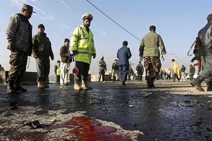 Afghan security forces stand near the site of a suicide attack in Kabul on Dec 11, 2014.&nbsp;-- PHOTO: REUTERS