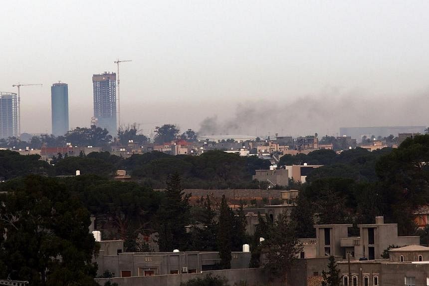 Smoke billows on Nov 25, 2014, from the Mitiga airport in a suburb of the Libyan capital Tripoli, held by anti-government militias, after an airstrike by forces loyal to Libya government.&nbsp;The EU barred all Libyan airlines from European airspace 