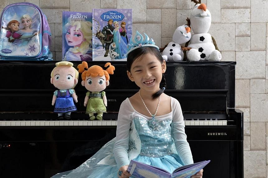 Six-year-old Clare Lim loves the film Frozen and sings the songs from its soundtrack every day. -- ST PHOTO: DESMOND FOO