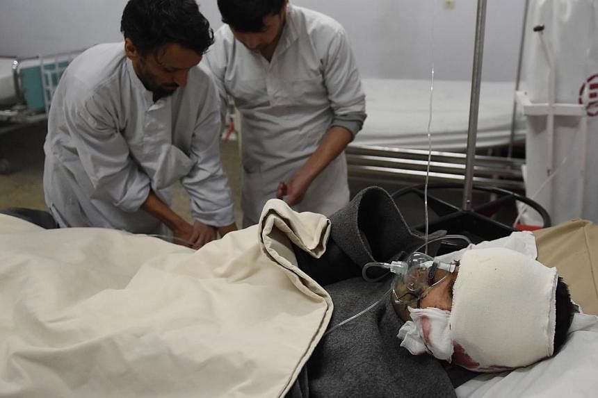 A wounded Afghan man receives treatment at an Italian aid hospital after a bomber blew himself up in the audience watching a theatre show at the Istiqlal High School which is attached to the French cultural centre in Kabul on Dec 11, 2014.Two suicide