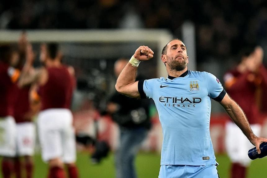 Manchester City's Argentinian defender Pablo Zabaleta celebrates after scoring during the UEFA Champions League football match AS Roma vs Manchester City at the Olympic stadium in Rome on Dec 10, 2014. -- PHOTO: AFP&nbsp;