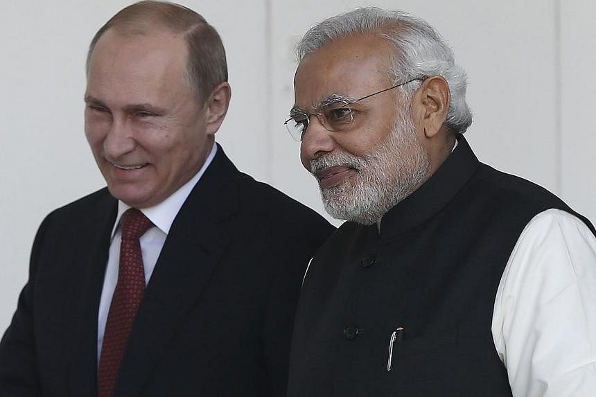 Russian President Vladimir Putin (left) and India's Prime Minister Narendra Modi arrives for a photo opportunity ahead of their meeting at Hyderabad House in New Delhi, India on Dec 11, 2014. -- PHOTO: REUTERS
