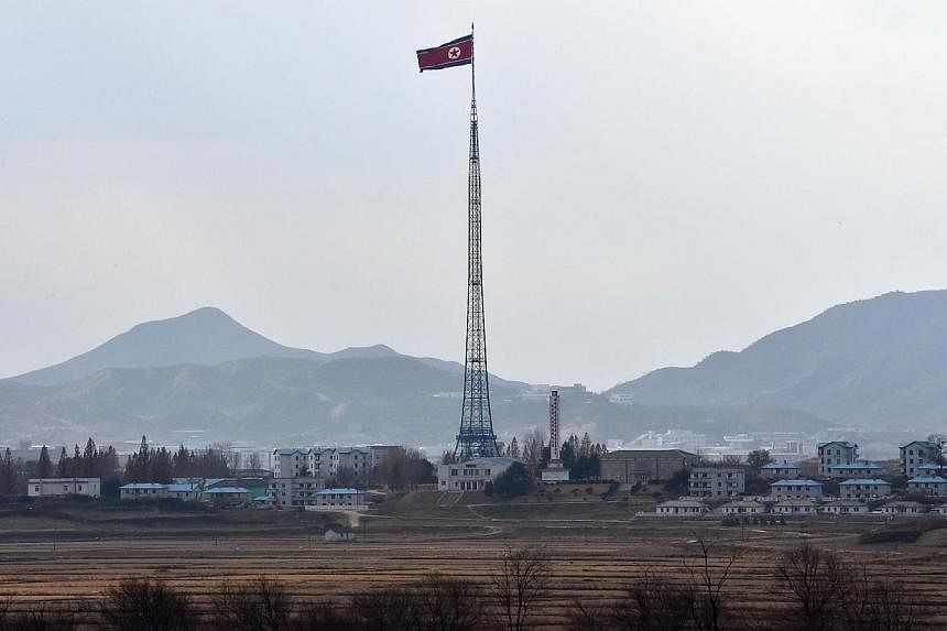 A North Korean flag flutters in the village of Gijungdong on Nov 12, 2014. -- PHOTO: AFP