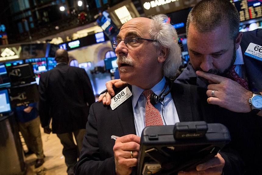 Traders work on the floor of the New York Stock Exchange on Dec 10, 2014, in New York City. -- PHOTO: AFP