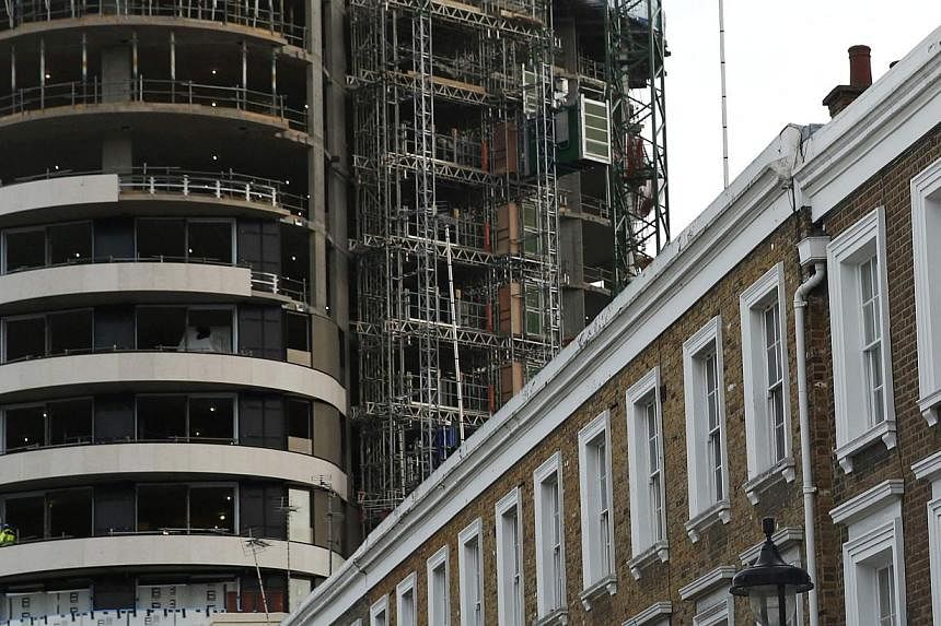 An apartment block under construction behind a row of traditional properties in central London on Dec 11, 2014. A British housing crash is among the 10 extreme scenarios that could become reality next year and turn global markets upside down, Saxo Ba