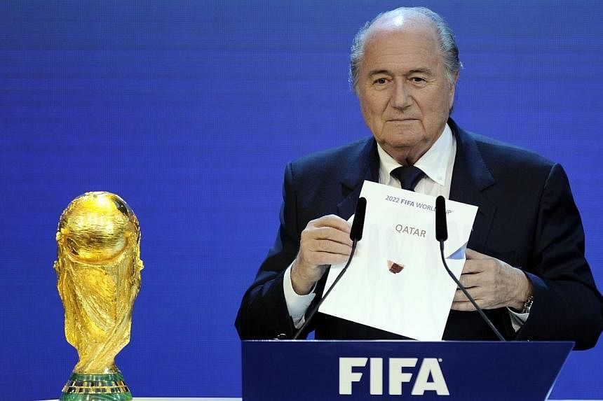 FIFA President Sepp Blatter holding up the name of Qatar during the official announcement of the 2022 World Cup host country at the FIFA headquarters in Zurich on Dec 2, 2010.&nbsp;Swiss lawmakers on Friday approved a bill to increase the financial s