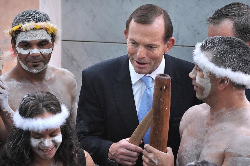 This file photo taken on Nov 12, 2013, shows Australian Prime Minister Tony Abbott (centre) speaking with Aboriginal performers at the opening of the 44th Parliament in Canberra.&nbsp;Australian Prime Minister Tony Abbott has declared himself ready t