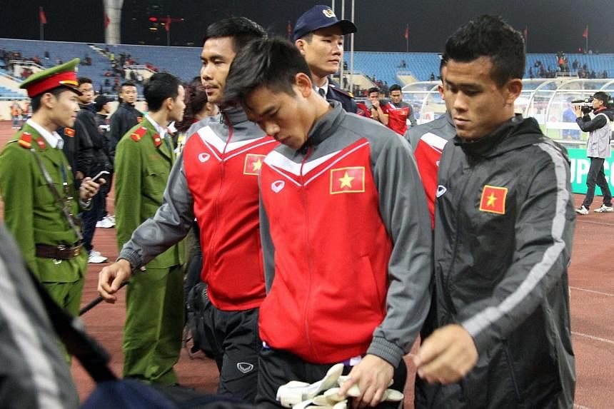 Vietnam's players react after Vietnam was defeated by Malaysia in the semi-final AFF Suzuki Cup return match at Hanoi's My Dinh stadium on Dec 11, 2014.&nbsp;Vietnam's football authorities will investigate the country's team for suspected foul play a
