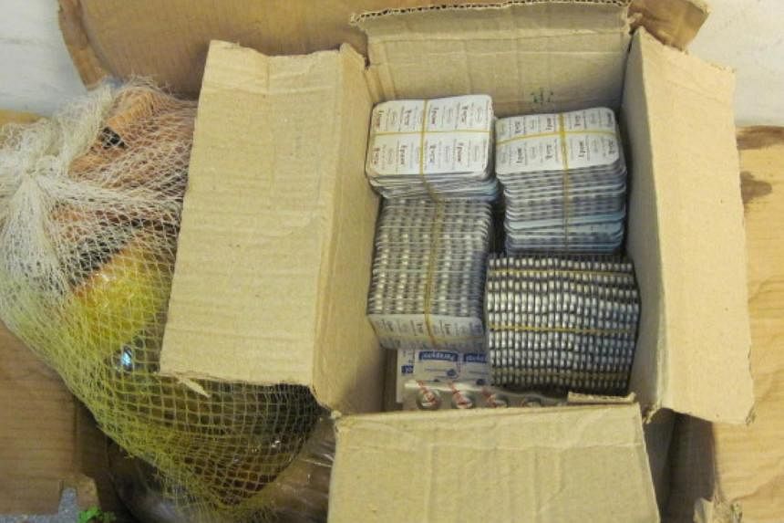 A total of 3,520 sleeping pills were seized from a male Bangladesh national at Changi Airport on Thursday. -- PHOTO: ICA