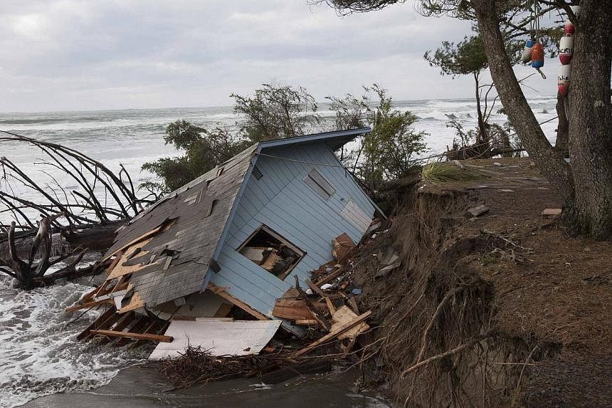 A home sits off of its foundation in Washaway Beach, Washington on Dec 11, 2014, as a Pacific winter storm hits the western United States.&nbsp;A major storm that pummeled northern California and the Pacific Northwest with heavy rain and high winds a