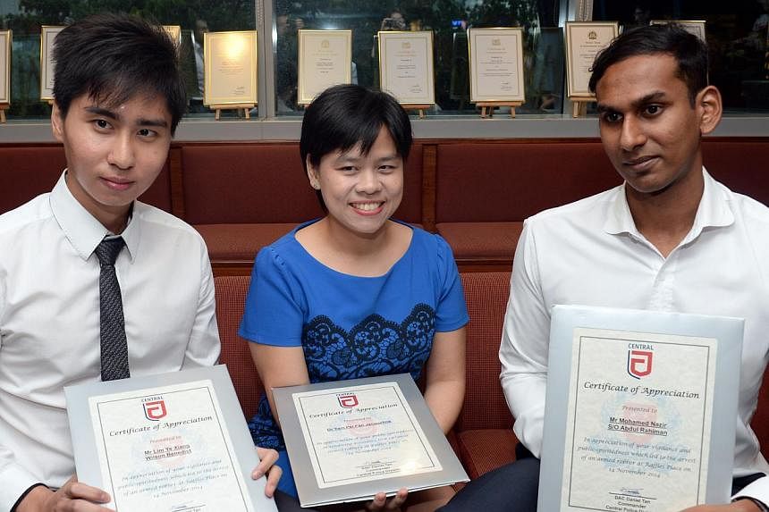 (From left) Mr Wilson Benedict Lim, Dr Jacqueline Yam and Mr Mohamed Nazir Abdul Rahiman received police commendations for helping to detain the suspect and tending to the victim in the Nov 14 robbery in Raffles Place.