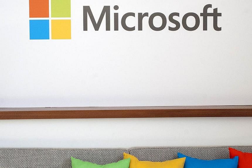 A March 27, 2014 file photo shows the Microsoft logo seen in San Francisco, California.&nbsp;Microsoft began Thursday letting US shoppers at its online Windows Store pay with digital currency Bitcoin. -- PHOTO: AFP