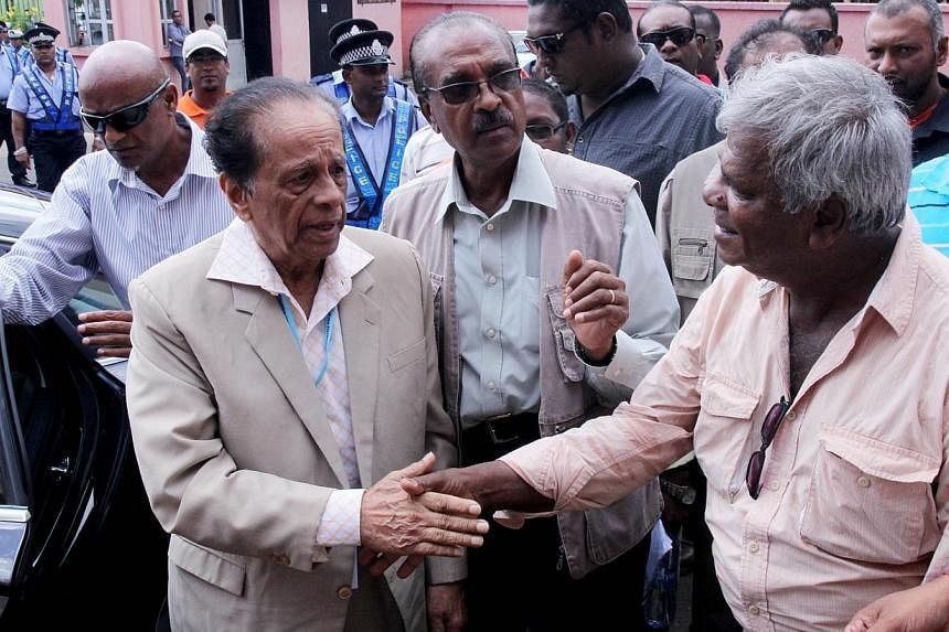 The outgoing prime minister of Mauritius accepted defeat Thursday in parliamentary polls, with power on the island nation now expected to transfer to opposition leader and ex-president Anerood Jugnauth, seen here (above left) greeting a supporter on 