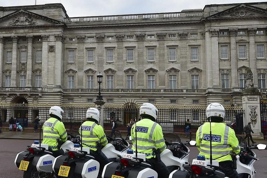 Police motorcycle outriders wait outside Buckingham Palace in central London, Oct 24, 2014.&nbsp;A species of hallucinogenic mushroom has been found growing wild in the grounds of Buckingham Palace, the main residence of Britain's Queen Elizabeth. --