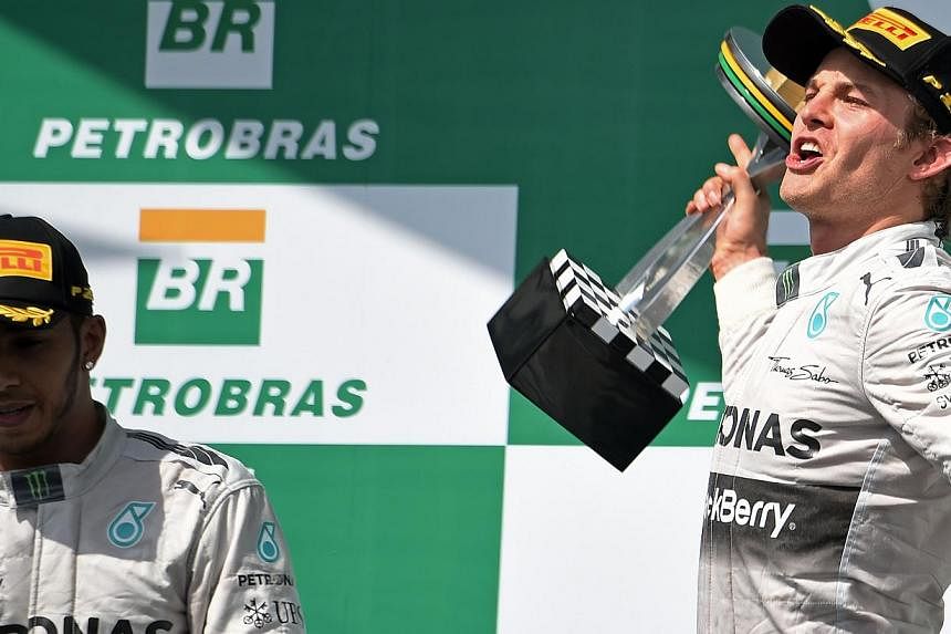 Driver Nico Rosberg (right) of Germany celebrates first place next to team-mate Lewis Hamilton (left) on the podium of the Brazilian Formula One Grand Prix on Nov 9, 2014. Formula One team principals have snubbed Mercedes driver Nico Rosberg in a bes
