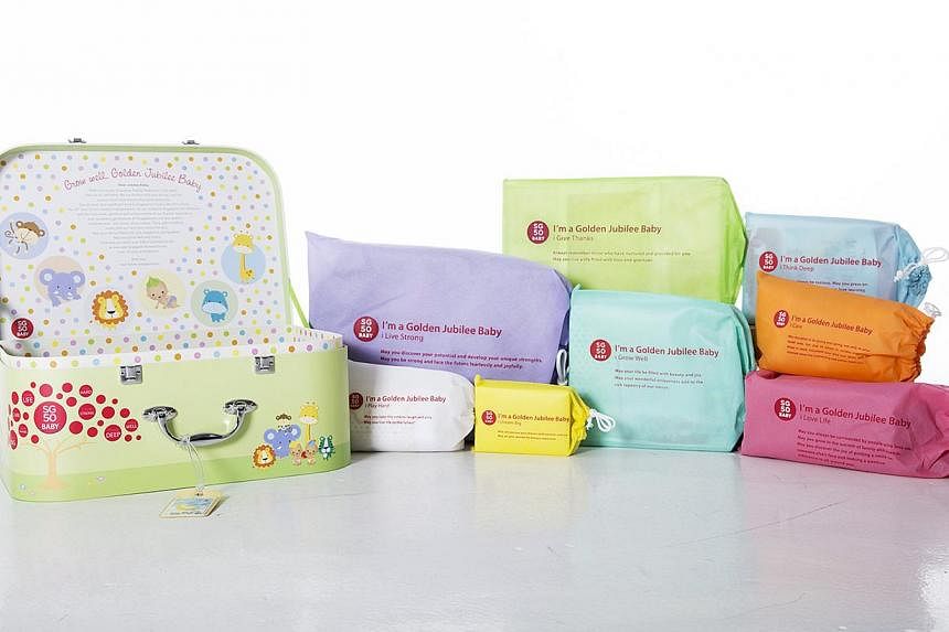 Some 4,000 SG50 baby gift sets have been packed and are ready to be delivered to the first babies born in 2015. The set consists of a medallion, shawl, baby sling, baby clothes, diaper bag, scrapbook, photo frame and baby books. -- PHOTO: THE NATIONA