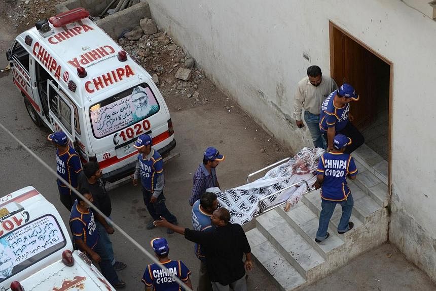 Pakistani rescuers stretcher a dead body of an alleged Taleban militant into a morgue in the city of Karachi on Oct 5, 2014, following a police operation.&nbsp;&nbsp;Pakistan police foiled a major terror attack on Saturday, Dec 13, 2014, in central P