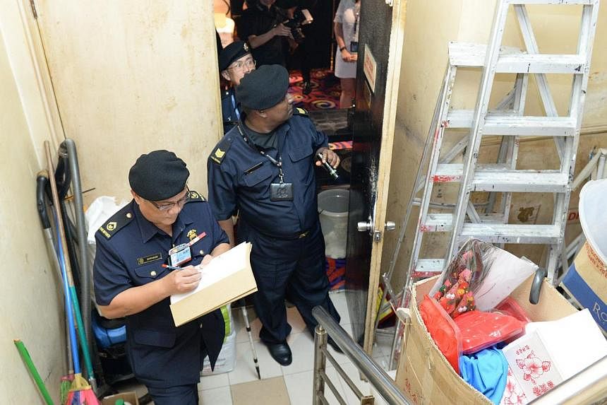 Officers from SCDF’s Central Enforcement Department conducting fire safety checks on Dec 12, 2014. -- PHOTO: SCDF