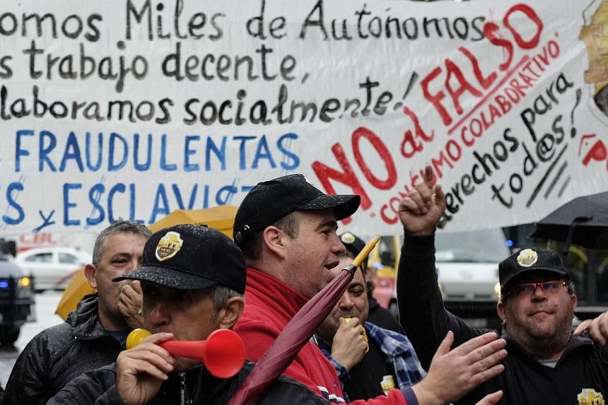 A protest by taxi drivers against Uber in Madrid in October. Most nations have rules to introduce a taxi service, but Uber's standard operating formula is to argue that no laws apply to the company.