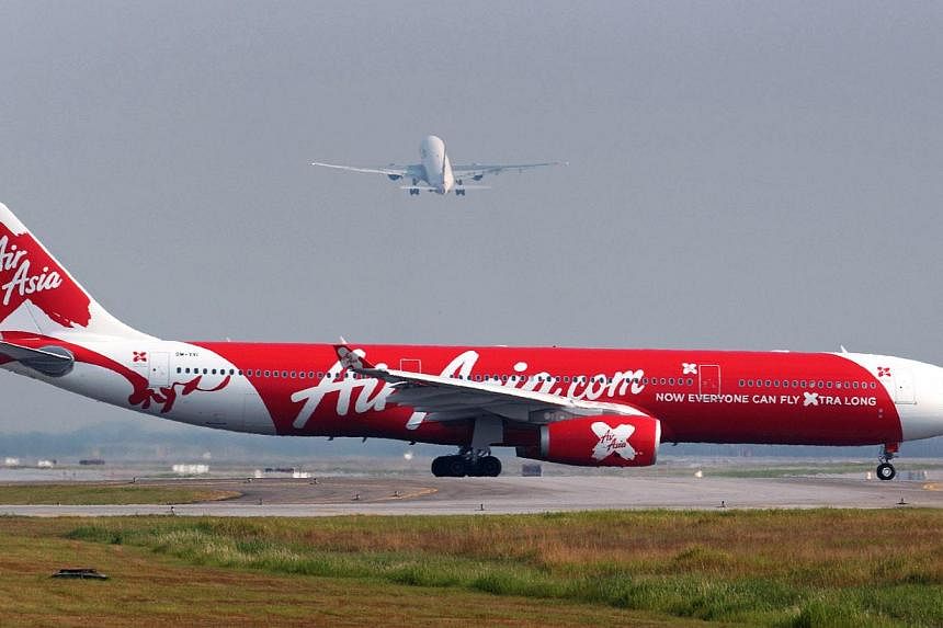 An AirAsia flight carrying passengers from Thailand to China was forced to return to Bangkok after a Chinese passenger threw hot water at a cabin attendant, the airline said on Saturday, Dec 13, 2014.&nbsp;-- PHOTO: BLOOMBERG