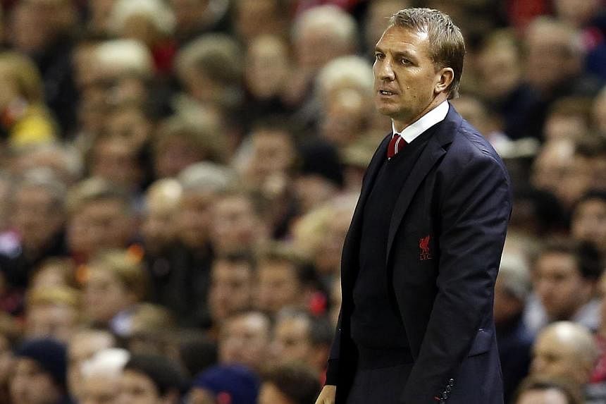Brendan Rodgers (above) insists Liverpool can still compete with Manchester United in the transfer market despite their contrasting results in the last window. -- PHOTO: REUTERS