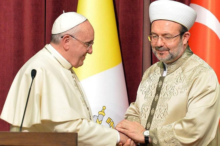 Turkey's top cleric&nbsp;Mehmet Gormez (right) meeting Pope Francis in Ankara, Turkey, on Nov 28, 2014. The Pope, who has made a point of eschewing luxury, opted to ride in a Renault Symbol during his visit to Turkey. -- PHOTO:&nbsp;AFP