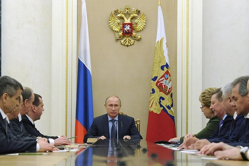 Russia's President Vladimir Putin (centre) chairs a meeting with permanent members of the Security Council at the Kremlin in Moscow, Dec 12, 2014. Russia’s Foreign Ministry on Friday sternly criticised a Bill on Ukraine that passed the US Senate, s