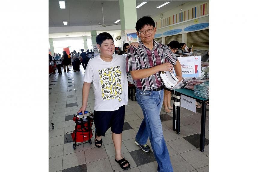 A record 400,000 textbooks, collected for the FairPrice Share-A-Textbook Project, were given out free to needy students on Dec 13.&nbsp;-- ST PHOTO: CHEW SENG KIM