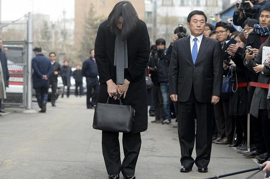 Cho Hyun-ah, also known as Heather Cho, daughter of chairman of Korean Air Lines, Cho Yang-ho, bows in front of the media outside the offices of the Aviation and Railway Accident Investigation Board of the Ministry of Land, Infrastructure, Transport,