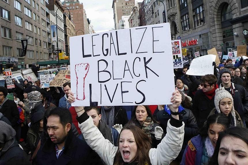 People march down 14th Street on Dec 13, 2014 in New York City. Thousands of protesters paralysed parts of New York and Washington on Saturday, stepping up demonstrations across the United States demanding justice for black men killed by white police