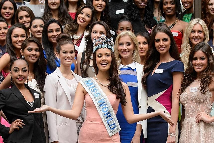 In a file picture taken on Nov 25, 2014, Miss World 2014 contestants, led by the current Miss World, Megan Young from the Philippines, pose for pictures at a photocall in central London. -- PHOTO: AFP