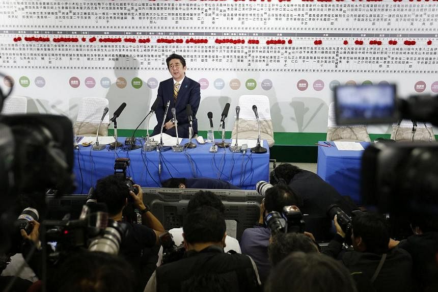 Japan's Prime Minister Shinzo Abe, who is also leader of the ruling Liberal Democratic Party (LDP), speaks during a news conference at the LDP headquarters in Tokyo on Dec 14, 2014. -- PHOTO: REUTERS
