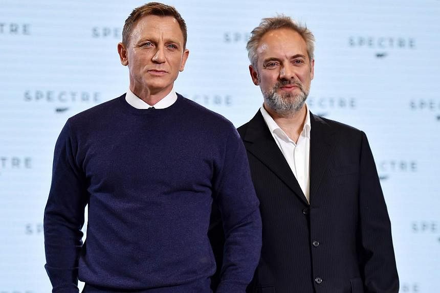 British director Sam Mendes (right) and actor Daniel Craig (left) pose during an event to launch the 24th James Bond film Spectre at Pinewood Studios at Iver Heath in Buckinghamshire, west of London, on Dec 4, 2014. -- PHOTO: AFP