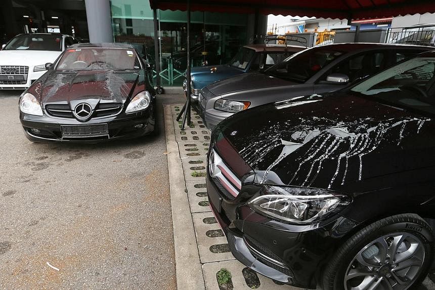 The paintwork of the cars has corroded because of the attack at the workshop in Redhill. The vehicles were not broken into and nothing was stolen from the workshop. -- ST PHOTO: SEAH KWANG PENG