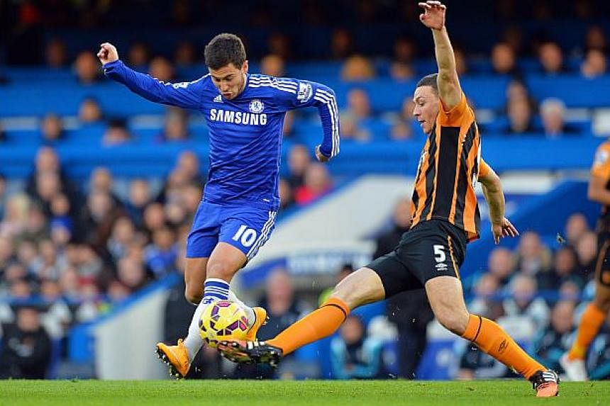 Chelsea's Belgian midfielder Eden Hazard (left) vies with Hull City's English defender James Chester (right) during the English Premier League football match between Chelsea and Hull City at Stamford Bridge in London on Dec 13, 2014. Leaders Chelsea 