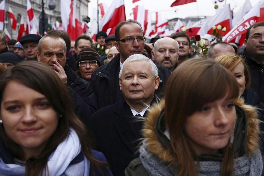 Jaroslaw Kaczynski (centre rear), leader of the Polish Law and Justice (PiS) party, takes part in a demonstration march in Warsaw Dec 13, 2014.&nbsp;Several thousand Polish opposition supporters marched in the capital Warsaw on Saturday to denounce a