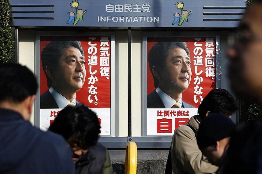 Posters of Japan's Prime Minister Shinzo Abe, leader of the ruling Liberal Democratic Party (LDP), in Tokyo on Dec 14, 2014. He won a comfortable re-election on Sunday in a snap poll he had billed as a referendum on his economic policies, but a recor