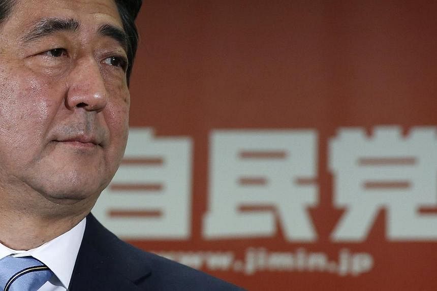 Japan's Prime Minister and the leader of the ruling Liberal Democratic Party (LDP), Shinzo Abe, attends a news conference following a victory in the lower house elections by his ruling coalition, at the LDP headquarters in Tokyo on Dec 15, 2014. -- P