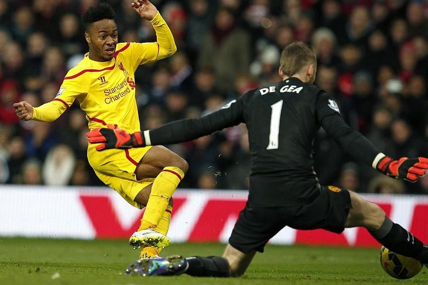 Manchester United goalkeeper David De Gea (right) makes a save from Liverpool's Raheem Sterling during their English Premier League soccer match at Old Trafford in Manchester, northern England on Dec 14, 2014. -- PHOTO: REUTERS
