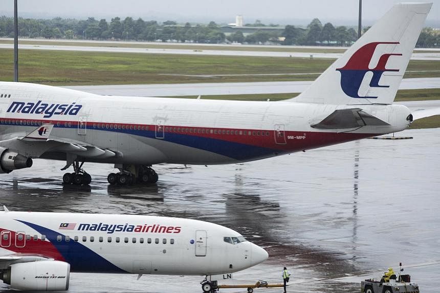 Malaysia Airlines suspended its shares from the country's stock exchange Monday under a government rescue plan for the flag carrier which is fighting for survival after losing two planes this year. -- PHOTO: BLOOMBERG