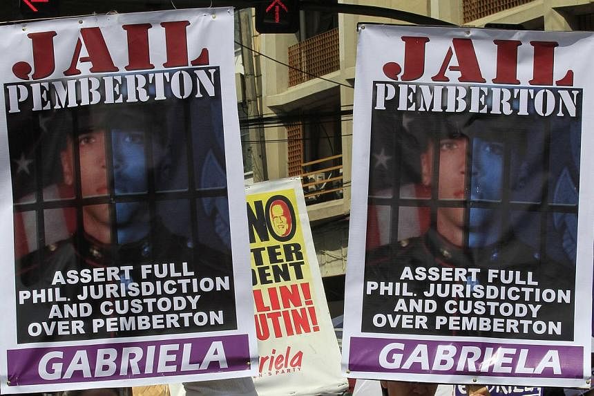 Activists display placards of US Marine Private First Class Joseph Scott Pemberton during a protest outside the presidential palace in Manila on Oct 28, 2014. -- PHOTO: REUTERS