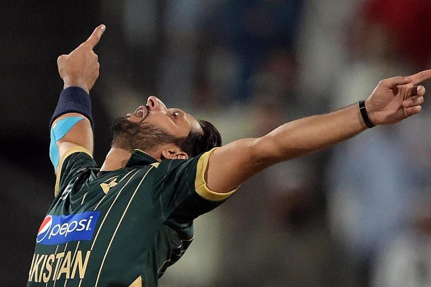 Pakistani captain and spinner Shahid Afridi celebrates after taking the wicket of New Zealand batsman Luke Ronchi during the third Day-Night International cricket match between Pakistan and New Zealand at the Sharjah cricket stadium in Sharjah on Sun