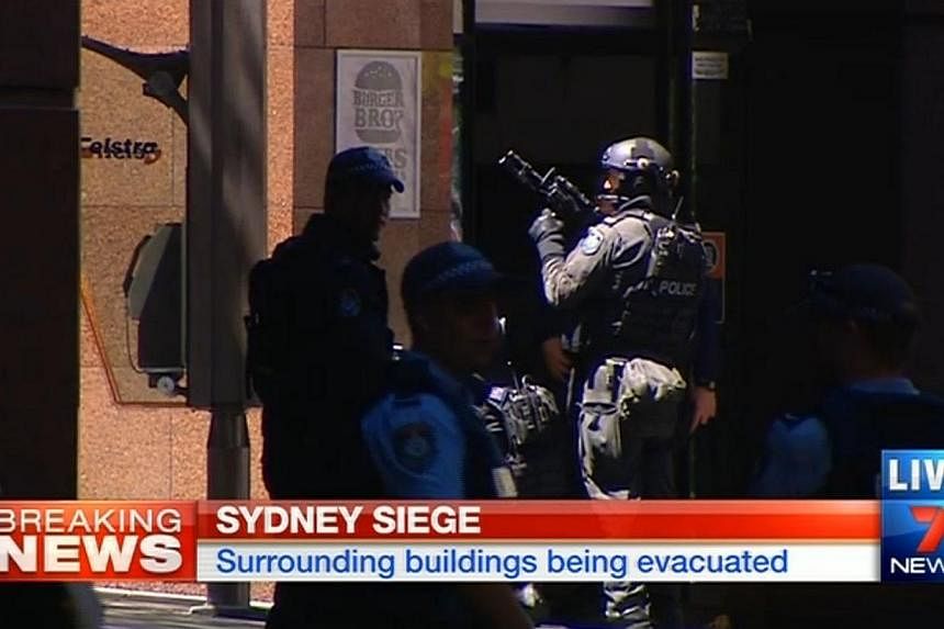 Screengrab from 7 News broadcasting live from the scene of the seige in Sydney. -- PHOTO: 7 NEWS