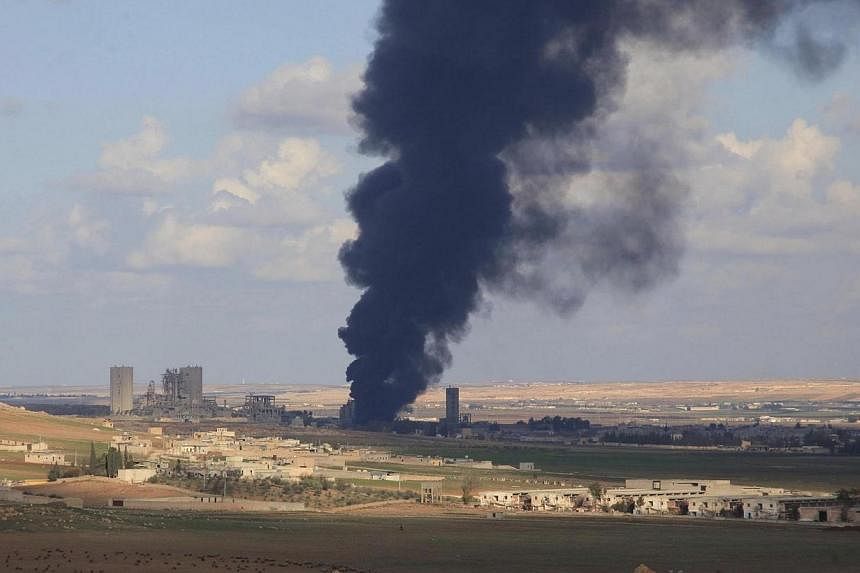 Smoke rises from burning warehouses, reportedly belonging to rebel fighters, in al-Maslamiyeh village,&nbsp;after Syria's army regained control of the area in north of Aleppo on Dec 15, 2014.&nbsp;An Indonesian man suspected of facilitating trips by 